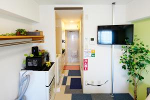an office corridor with a tv on the wall at Kameari 1105 Budget Stay High Floor Near Station Mall Disney Access in Tokyo