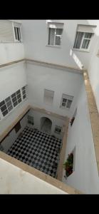 an empty room with a checkered floor in a building at Casa Murillo in El Puerto de Santa María