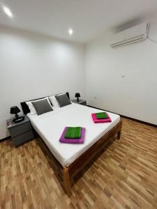 a bedroom with a bed with two pillows on it at Hotel Kenito in São Tomé