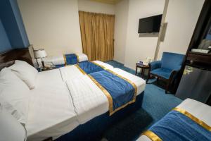Postel nebo postele na pokoji v ubytování Al Barakah Mawaddah Hotel