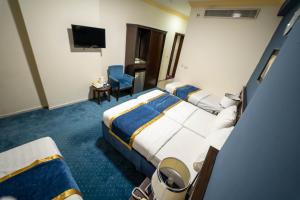 Postel nebo postele na pokoji v ubytování Al Barakah Mawaddah Hotel