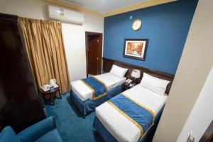 Postel nebo postele na pokoji v ubytování Al Barakah Mawaddah Hotel