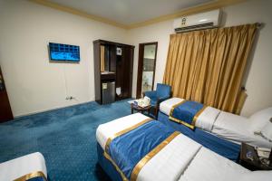 Postel nebo postele na pokoji v ubytování Al Barakah Mawaddah Hotel
