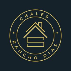 a gold circle logo with a house in the middle at Rancho Dias in Atins