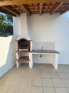 a kitchen with a sink on a patio at Casa do coral in Peniche
