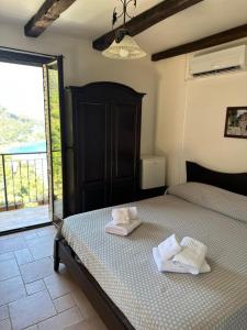 a bedroom with a bed with two towels on it at B&B La Bastia in Scilla