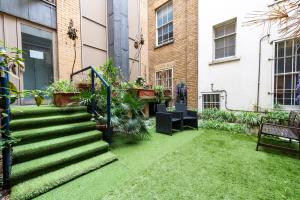 a garden with stairs and plants in a building at Piccadilly Circus by Capital in London
