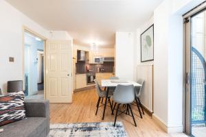 a living room with a couch and a table and chairs at Piccadilly Circus by Capital in London