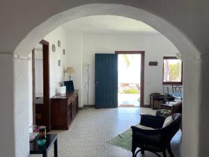 an archway in a living room with a couch and a table at Villa Baia del Riccio in Agnone Bagni