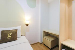 Postel nebo postele na pokoji v ubytování Hotel Gunawangsa Manyar