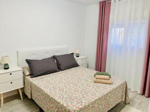 Ένα ή περισσότερα κρεβάτια σε δωμάτιο στο Apartamento Disfruta