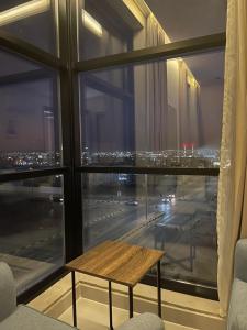 a view of a city from a window with a table at شقق عالية الاطلالة Serv Apartment in Hafr Al-Batin