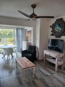 a living room with a couch and a tv and a table at 22 Key Largo in Kingsborough