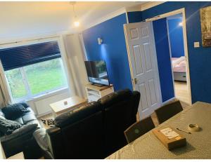 a living room with a couch and a television at Charming 6-Bed House in Reading in Reading