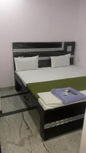 En eller flere senge i et værelse på OYO Rajdhani Guest House