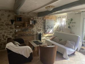 a living room with a couch and chairs at Typique maison de village in Peille