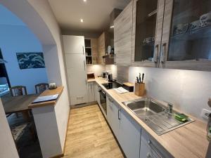 a kitchen with a sink and a counter top at Top 1 Gartenwohnung in Kitzbühel