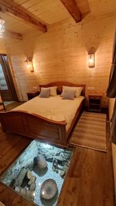a bedroom with a bed and a fish pond in it at Casa de Lemn Maramures in Mara
