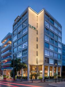 a tall white building on a city street at Brown Kubic, a member of Brown Hotels in Athens