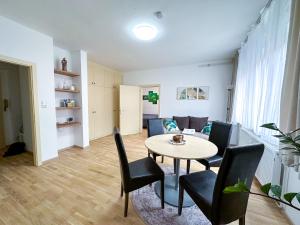 a dining room and living room with a table and chairs at Wohnung zum Wohlfühlen! in Feldbach