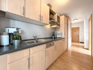 a kitchen with a sink and a counter top at Waterkant Wohnung 21 - Netzboden in Boltenhagen