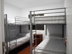 two bunk beds in a room with a desk at CASA RURAL TRIGUEROS in Córdoba