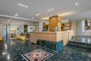 a lobby of a hotel with a reception counter at Brown Kubic, a member of Brown Hotels in Athens