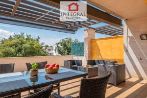 a patio with a table and chairs on a balcony at Casa Pool TimeOut in Palamós