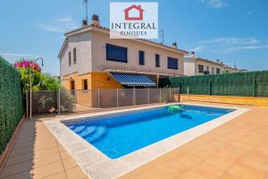 a villa with a swimming pool and a building at Casa Pool TimeOut in Palamós