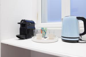 a coffee maker and a toaster on a counter at Design Apartment Spittelberg - 7th district - contactless checkin in Vienna