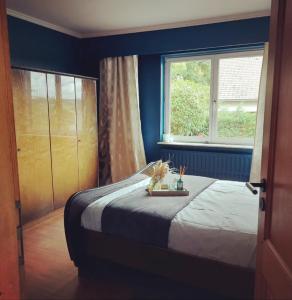 a bedroom with a bed and a window at Les amoureux du vrai in Malmedy