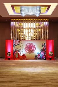 a stage with red curtains and a chandelier at Langham Place Guangzhou - Walking distance to Canton Fair in Guangzhou