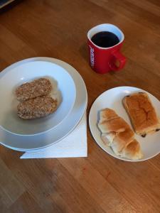 una mesa con dos platos de comida y una taza de café en Twin room in Prescot Homestay, en Prescot