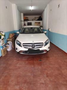 a white car is parked in a garage at Piso Granada 3 dormitorios y parking privado in Granada