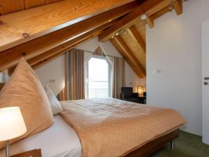 ヴァンゲン・イム・アルゴイにあるAlfreds Ferienbauernhofの木製の天井のベッドルーム1室(大型ベッド1台付)