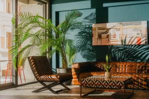 a living room with a couch and a chair at Sandali Metekhi Boutique Hotel in Tbilisi City