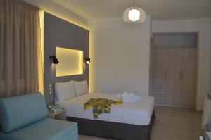 A bed or beds in a room at Ammos Apartments