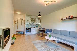 a living room with a blue couch and a table at Villa Kometa Pamporovo Cozy 1-BD Flat by Flat Mаnager in Pamporovo