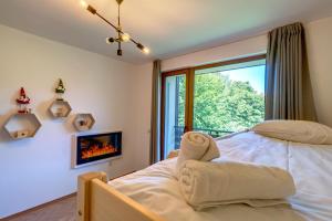 ein Schlafzimmer mit einem Bett und einem Kamin in der Unterkunft Villa Kometa Pamporovo: Cozy 1-BD Flat in Pamporowo