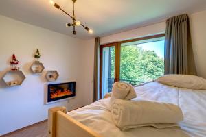 a bedroom with a bed and a fireplace at Villa Kometa Pamporovo Cozy 1-BD Flat by Flat Mаnager in Pamporovo