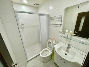 a bathroom with a toilet and a sink and a shower at 台中 晴文旅 in Taichung