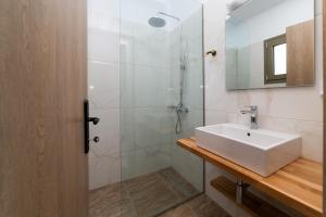 a bathroom with a sink and a shower at Sky View Suites Kefalonia in Vóvikes