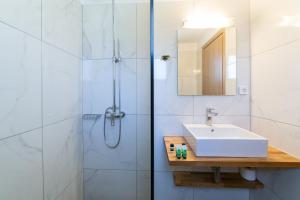 a bathroom with a sink and a shower at Sky View Suites Kefalonia in Vóvikes
