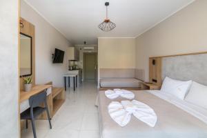 a bedroom with a bed with two bows on it at Sky View Suites Kefalonia in Vóvikes