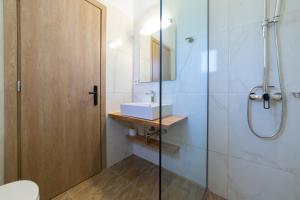 a bathroom with a sink and a shower at Sky View Suites Kefalonia in Vóvikes