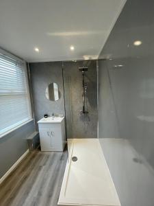 a bathroom with a shower and a sink at 78 Victoria Road in Liverpool