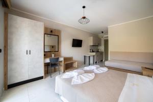 a hotel room with two beds and a kitchen at Sky View Suites Kefalonia in Vóvikes