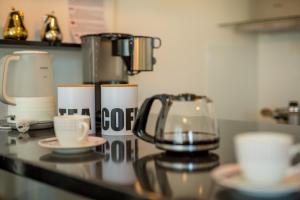 a counter with a coffee maker and cups on it at Casa Rose in Novigrad Istria