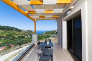a balcony with a view of the ocean at Sky View Suites Kefalonia in Vóvikes