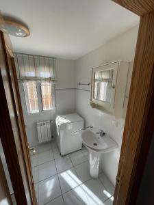 a white bathroom with a sink and a toilet at Villa Buena Vista in San Vicente del Raspeig